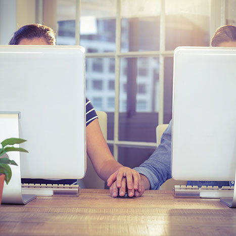 Couple holding hands at work